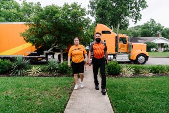 Two allied movers in front of a truck