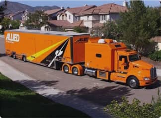 A large moving truck in front of a house