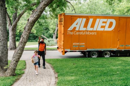 Allied Van Lines driver waving to young girl