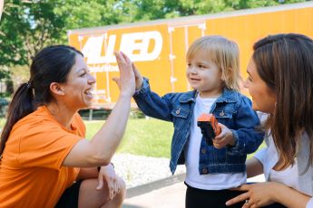 Allied van lines employee interacting with young child
