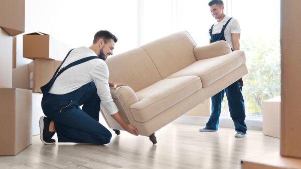 Two men moving a couch