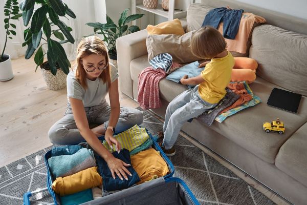 Young woman packing a suitcase