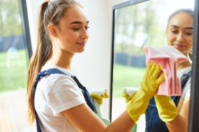 Woman cleaning mirrors