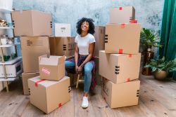 Woman sitting with moving boxes