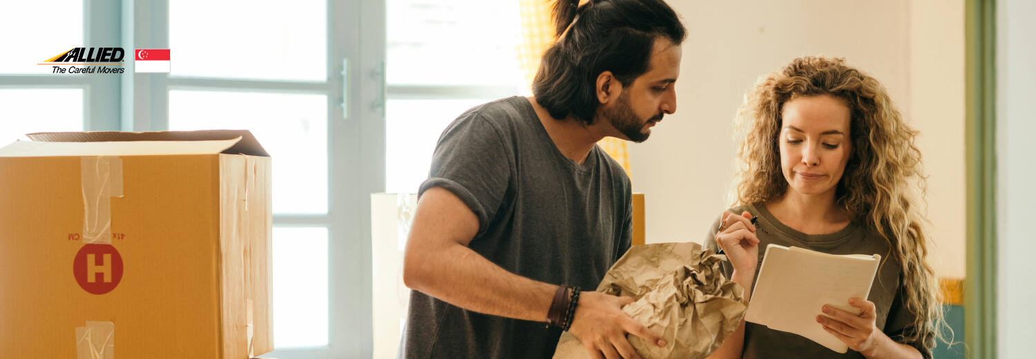 happy couple packing moving boxes