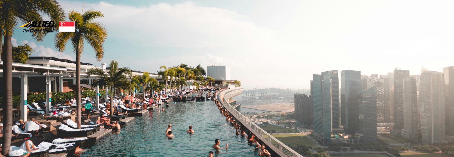 group of people at the swimming pool under white clouds at the marina bay sands hotel Singapore